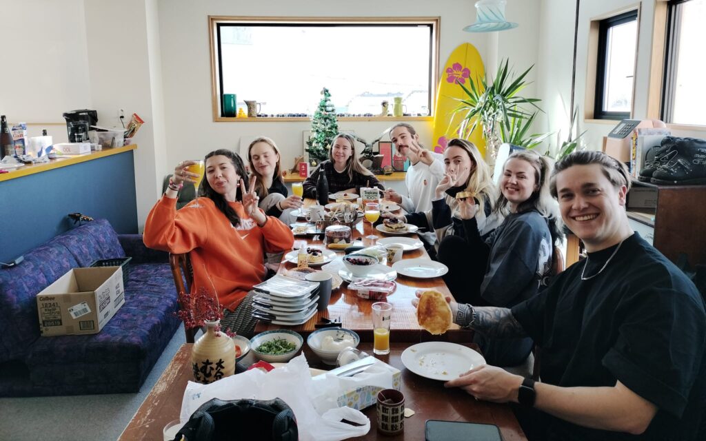 Working holiday visa workers sharing Christmas breakfast in Nozawa Onsen ski town