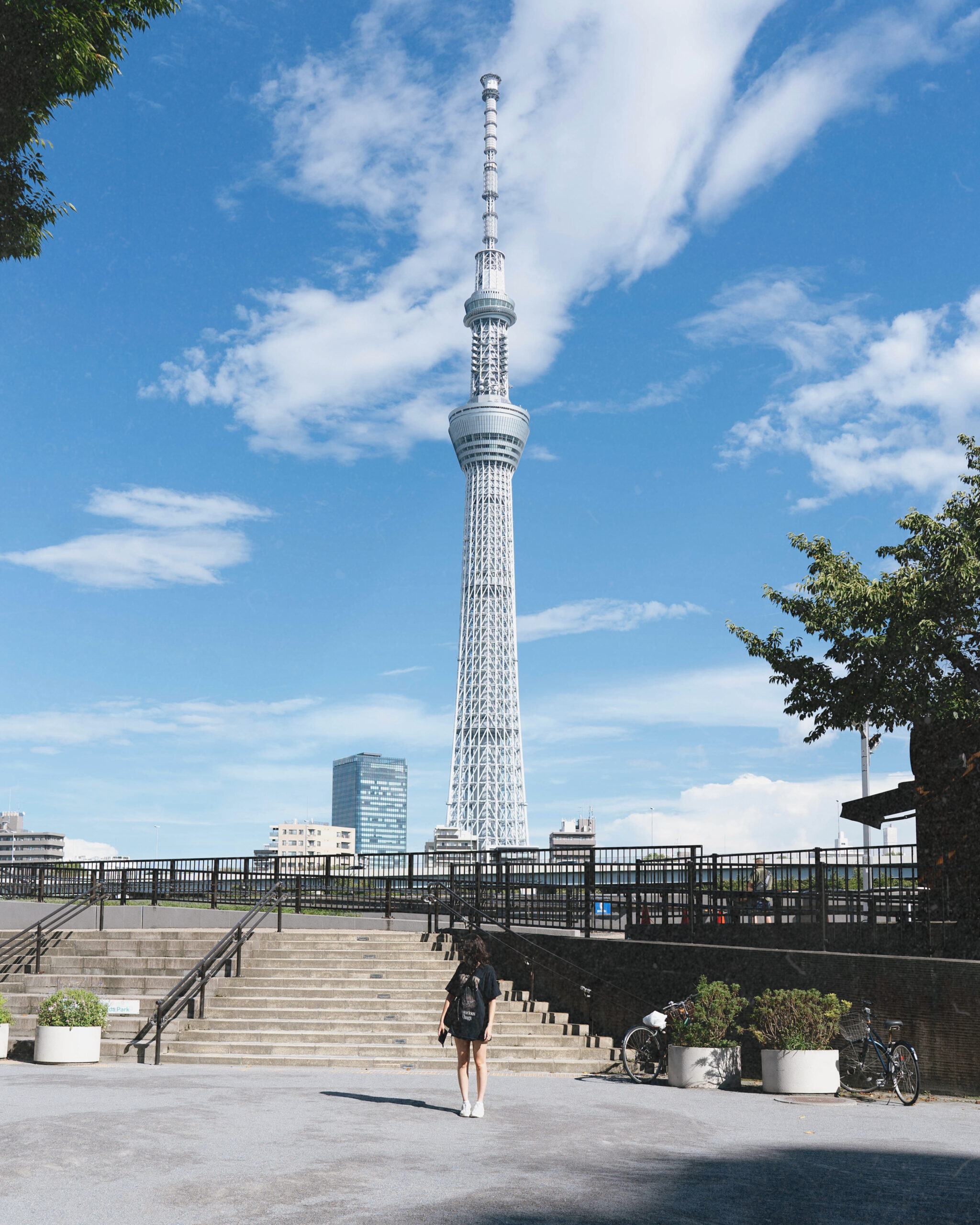 Sarah standing in front of Tokyo Skytree on a sunny day after moving to Japan