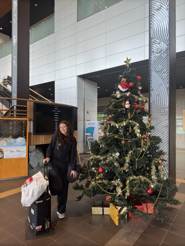 Sarah arriving at Iiyama Station in Japan with luggage after travelling on the Shinkansen using a Suica Card.