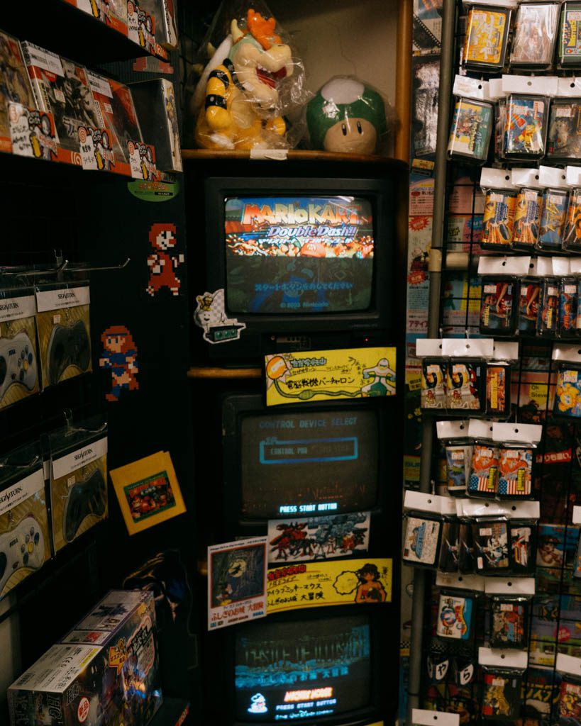 Shelves of retro game cartridges and CRT displays inside a backstreet Akihabara game shop