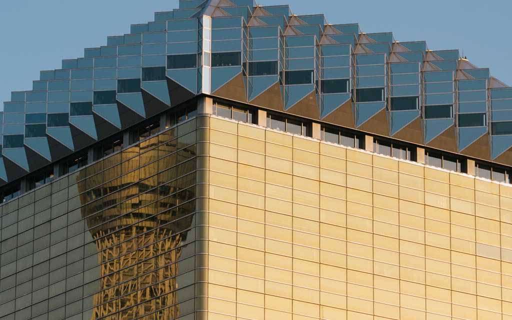 Asahi Beer Hall's gold facade with Tokyo Skytree reflected in the glass rooftop structure