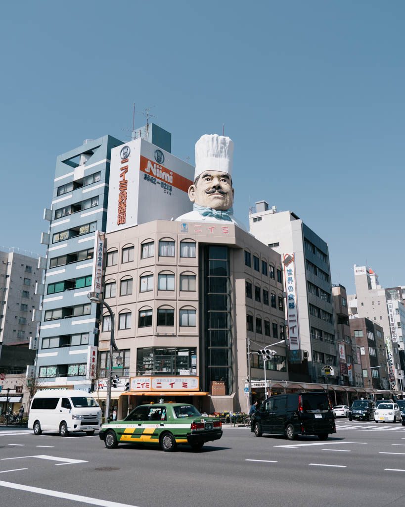 Giant chef statue atop the Niimi building, the landmark for Kappabashi kitchen supply street in Tokyo