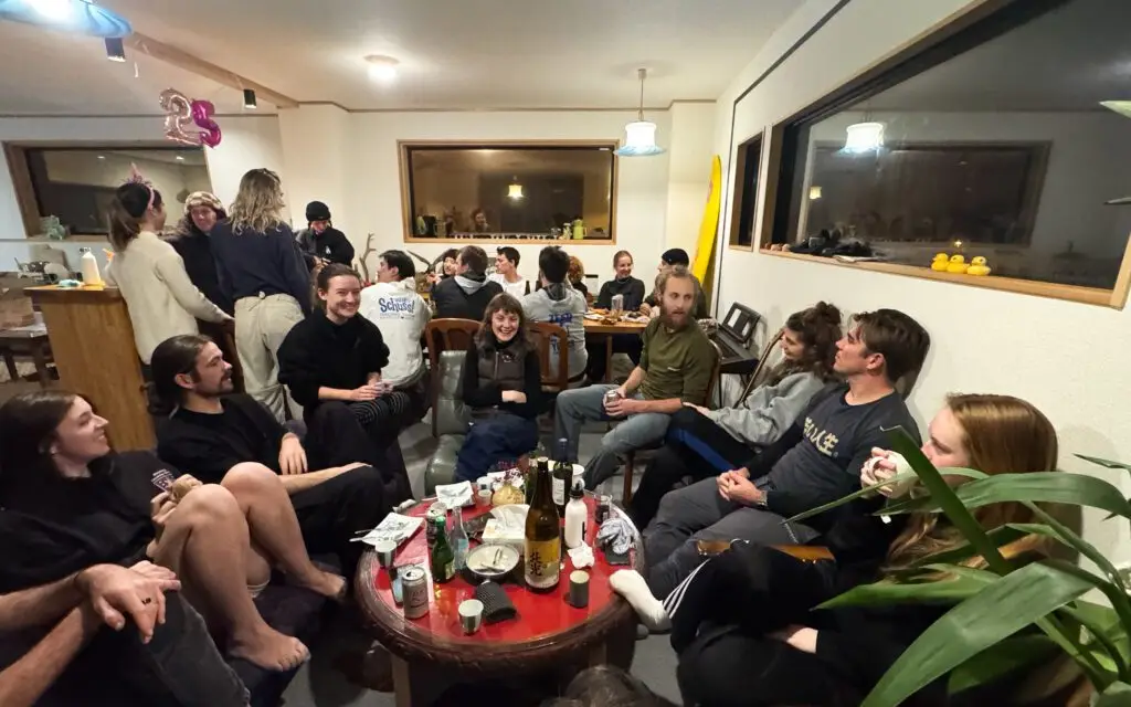 Staff birthday party in a Nozawa Onsen share house during ski season, showing seasonal workers celebrating together.