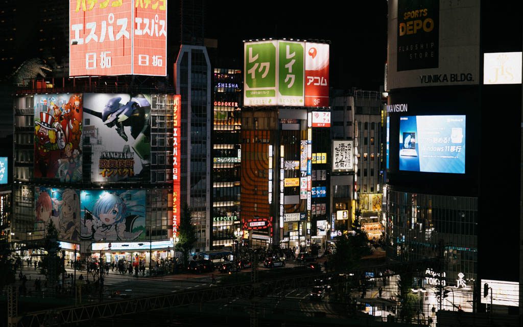 Illuminated pachinko parlour billboards and neon skyline in Shinjuku at night