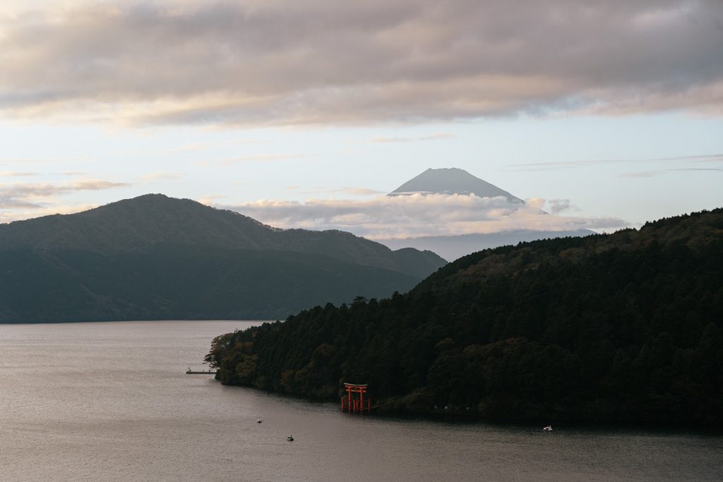 Hakone Shrine's torii gate in Lake Ashi with Mount Fuji visible in the distance