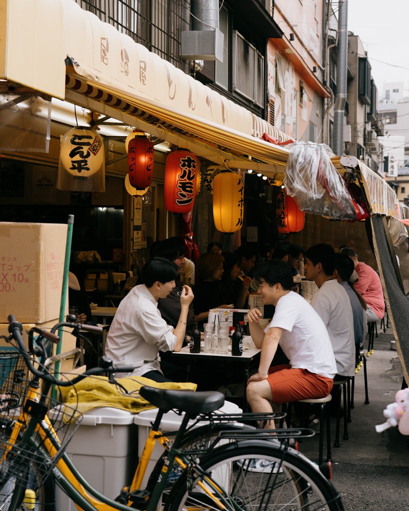 Diners enjoying an outdoor izakaya on Hoppy Street in Asakusa, Tokyo