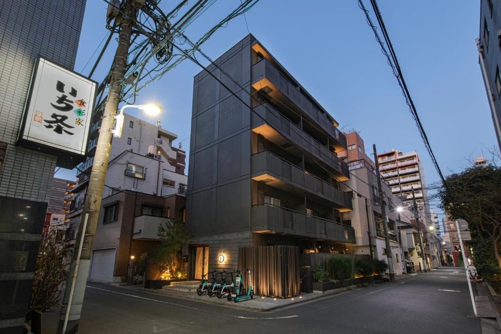 Exterior of Hotel Asakusa KANNONURA on a quiet residential street at dusk