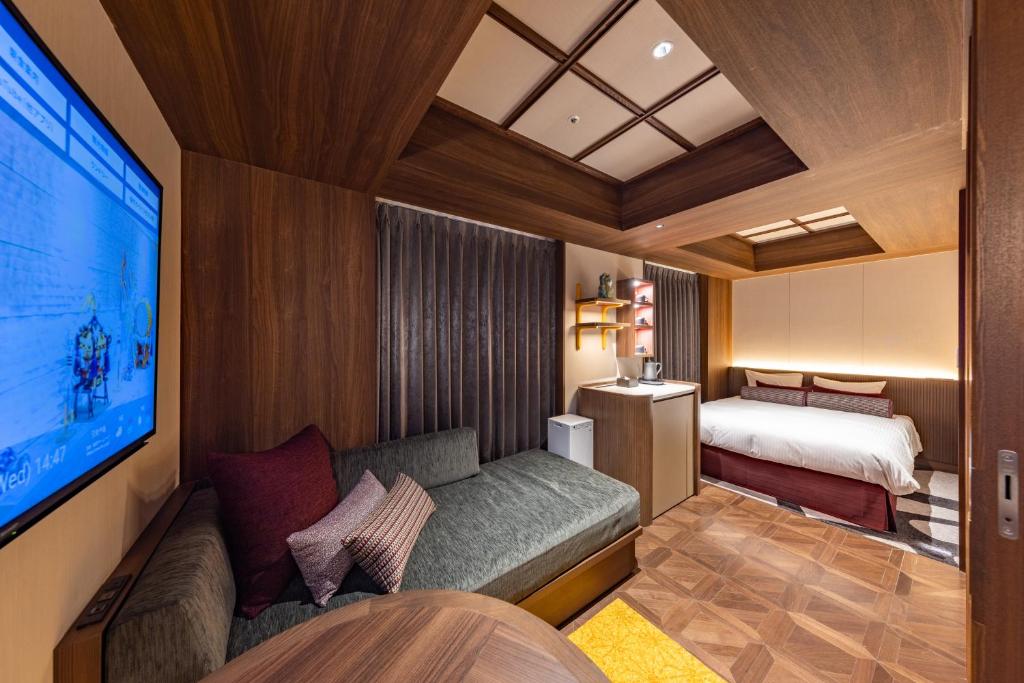 Modern guest room at Hotel Keihan Asakusa with wood panelling, a sofa, and burgundy accent pillows