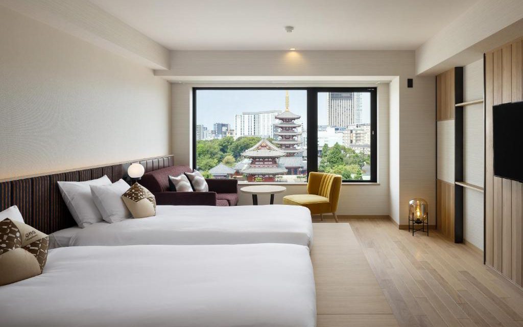 Modern twin room at OMO3 Asakusa with a window view of Senso-ji's pagoda
