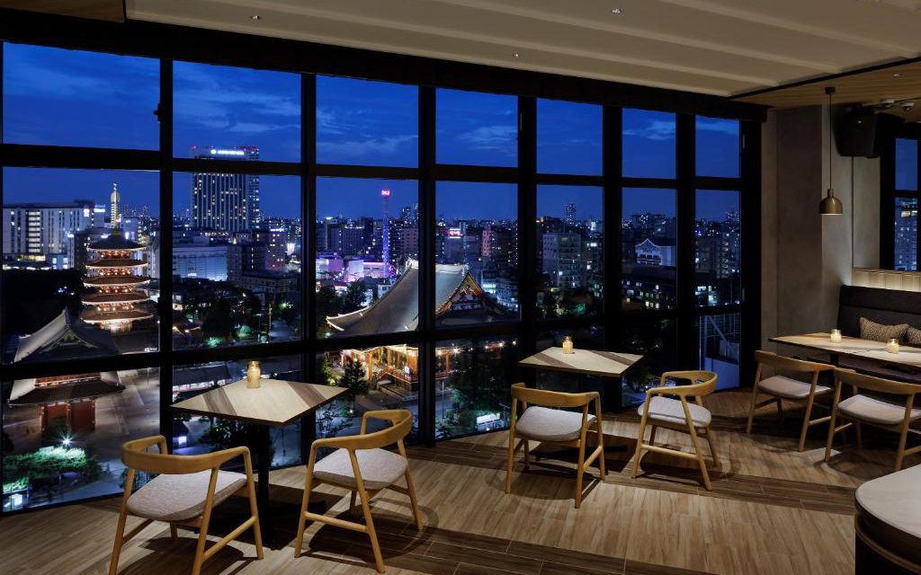 Rooftop bar seating at OMO3 Asakusa with a night view over Asakusa and Senso-ji