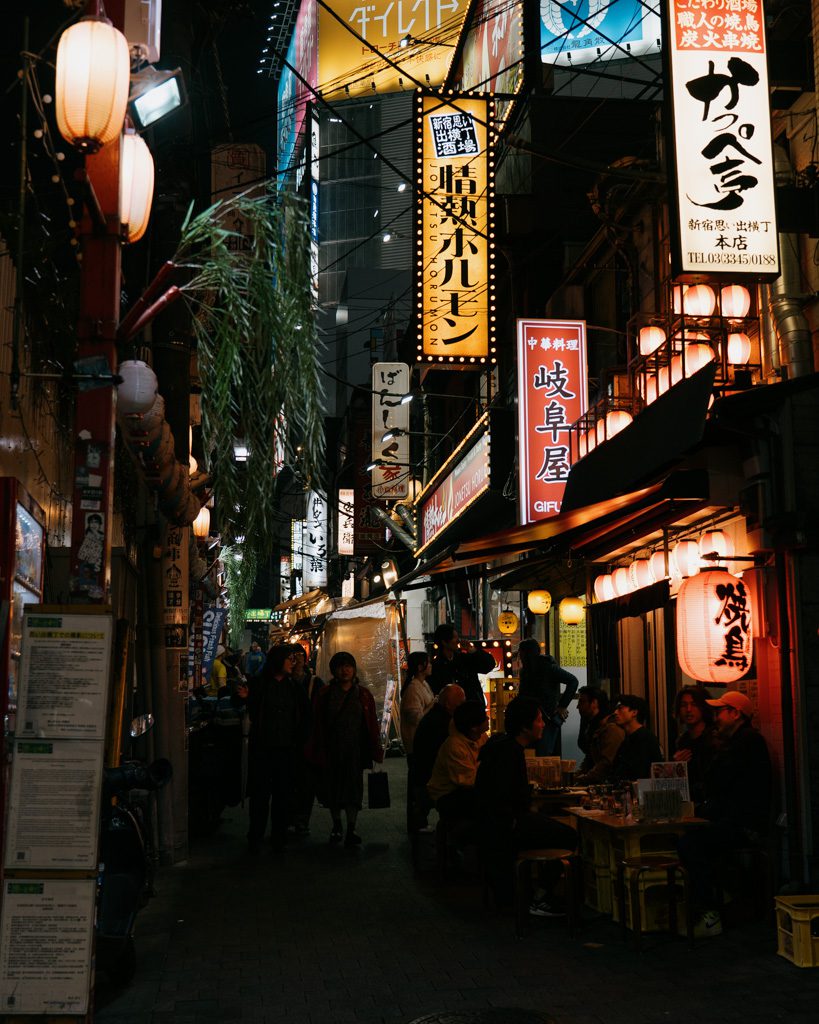 Narrow alley lined with lantern-lit izakaya restaurants in Omoide Yokocho