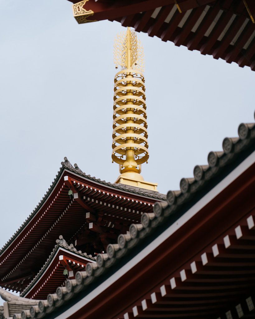 Close-up of the golden spire on Senso-ji's five-storey pagoda