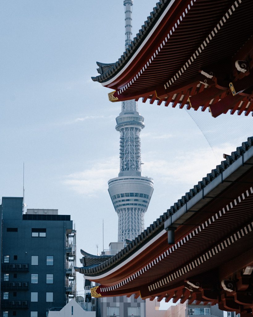 Senso-ji Temple's curved rooftops with Tokyo Skytree rising in the background. A view from our 1-day Tokyo itinerary.