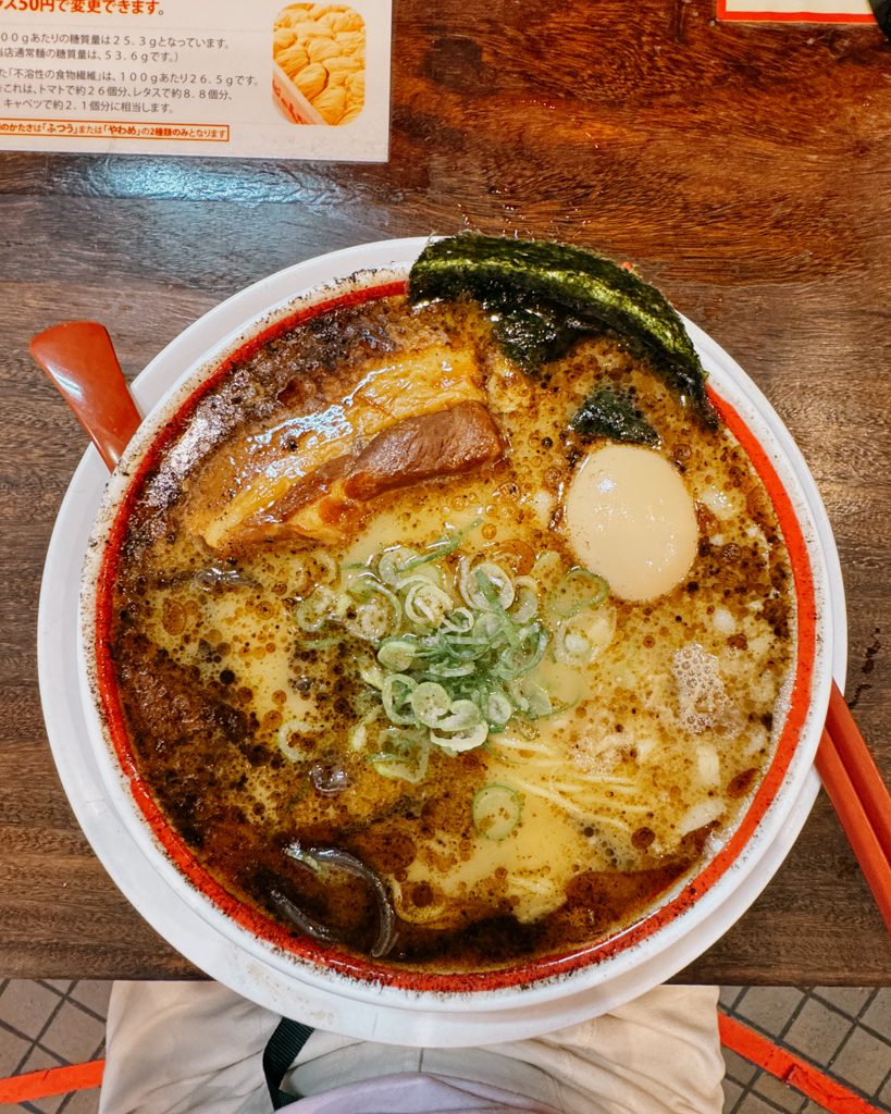Bowl of tonkotsu ramen topped with chashu pork, soft egg and nori