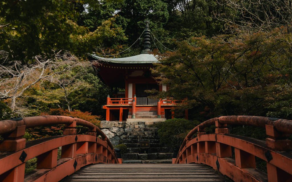 View across a red wooden bridge towards the Bentendo hall at Daigo-ji