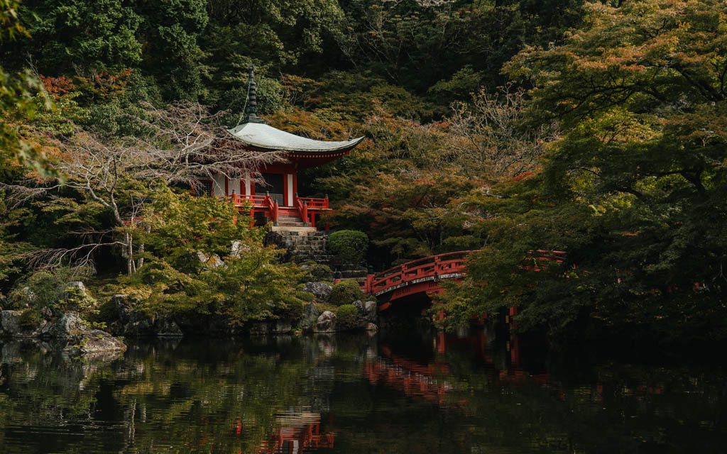 Bentendo hall and red bridge reflected in the pond at Daigo-ji in autumn