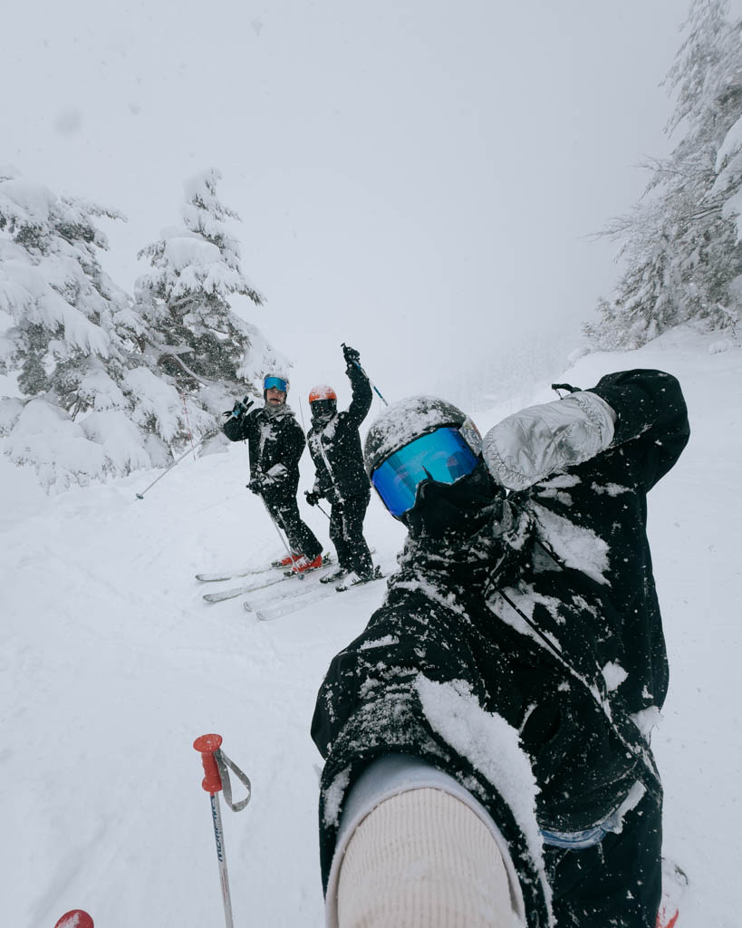 Group of skiers taking a selfie during a heavy snowfall day in Nozawa Onsen