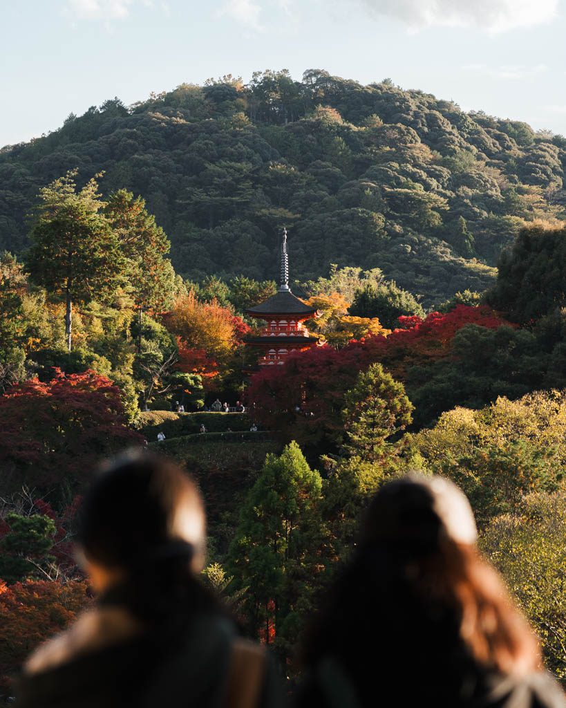 Distant view of a pagoda at Kiyomizu-dera framed by autumn trees