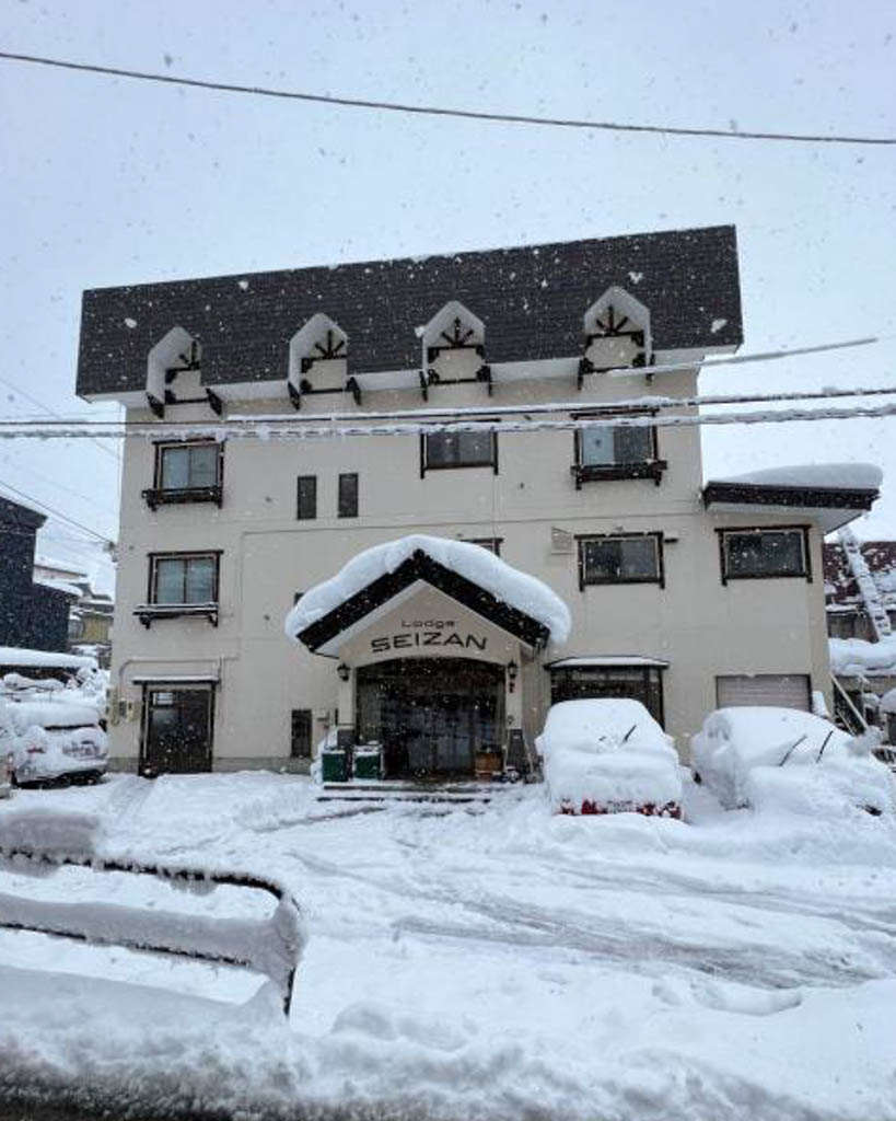 Snow-covered exterior of Lodge Seizan hotel entrance