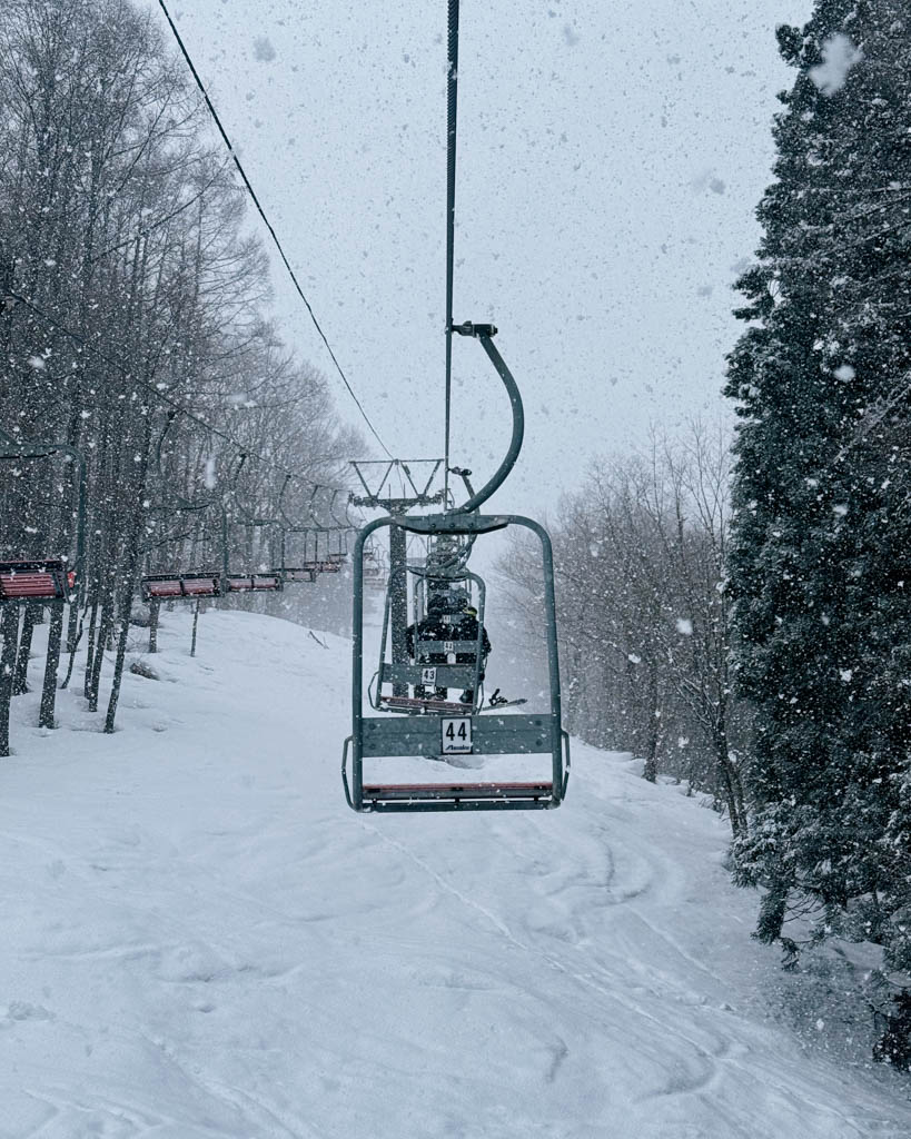 Riding the Nagasaka-Link chairlift through heavy snowfall in Nozawa