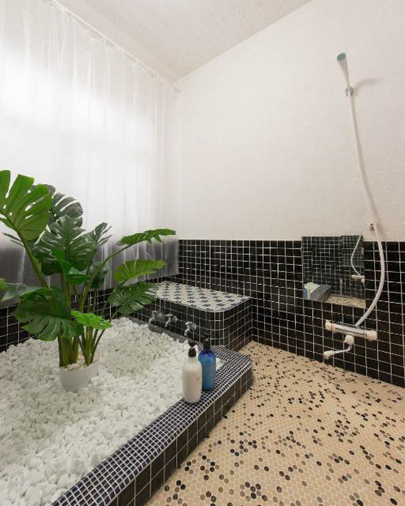 Nozawa Peaks tiled bathroom with shower and stone-filled bath