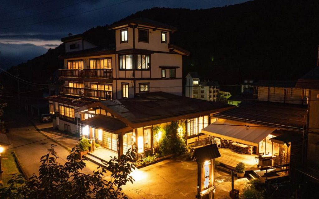 Shirakaba hotel exterior lit up at night in Nozawa Onsen