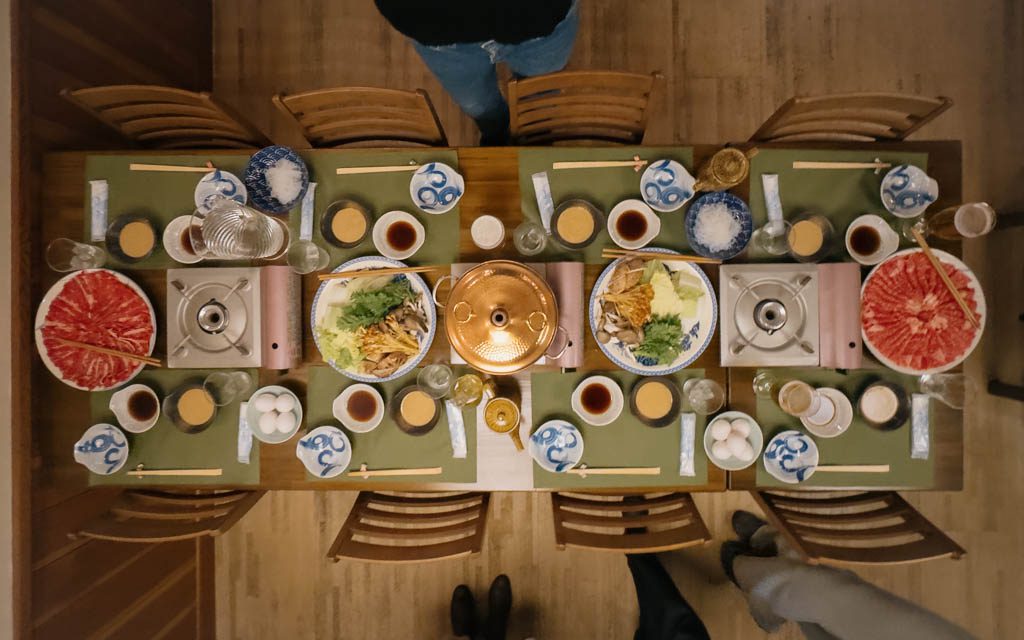 Overhead view of a wagyu shabu shabu and sukiyaki dinner spread on a table in Nozawa Onsen