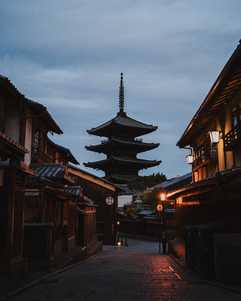 Yasaka Pagoda seen down a lantern-lit street in Kyoto at blue hour
