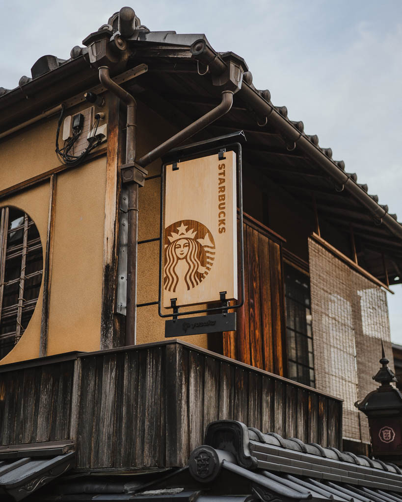 The Starbucks sign hanging from a traditional wooden building on Ninenzaka street in Kyoto